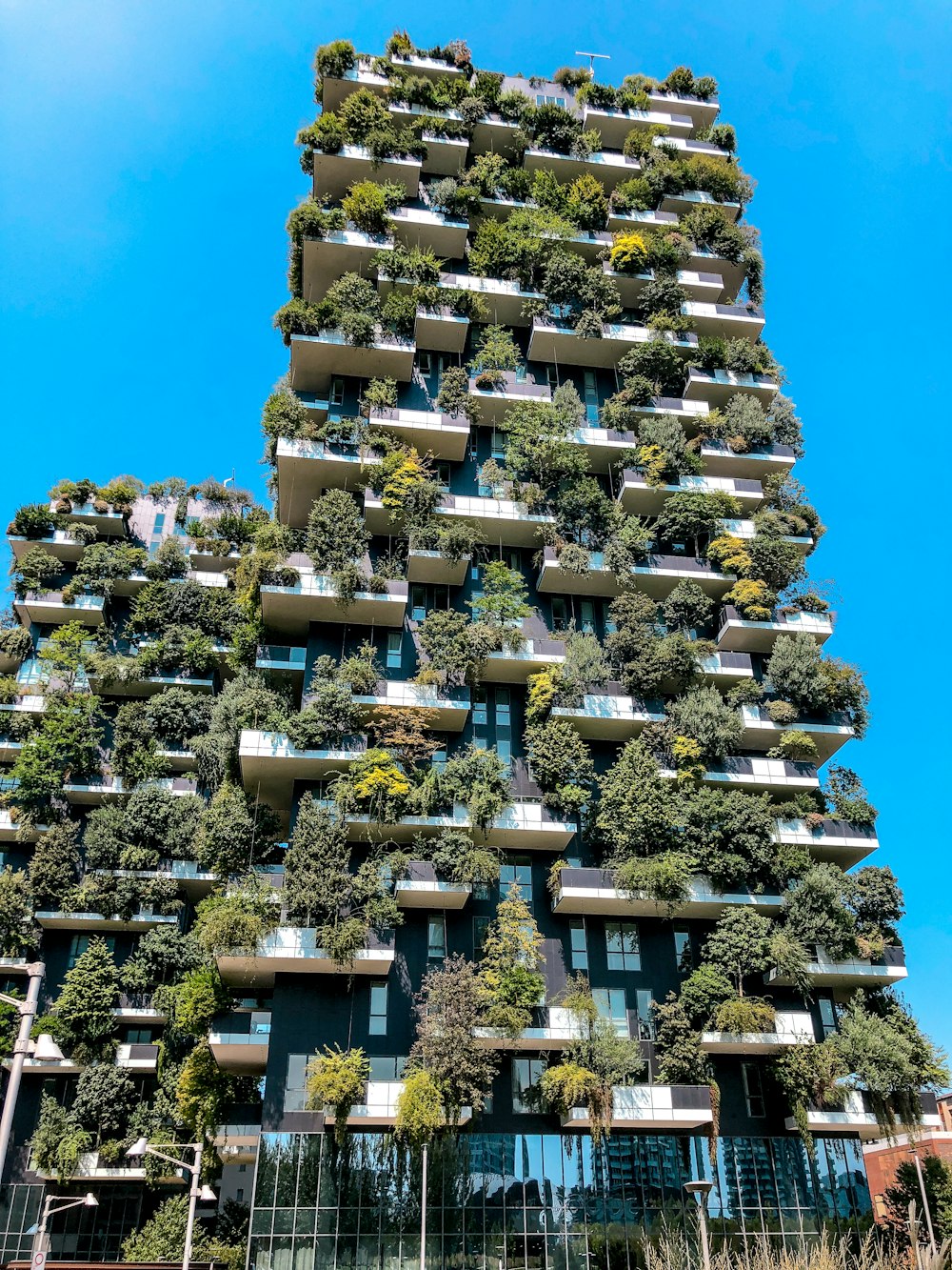 a very tall building with lots of plants growing on it