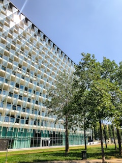 A panoramic view of Cyber Arch IT Park’s modern façade at Knowledge Park 5 under bright daylight.