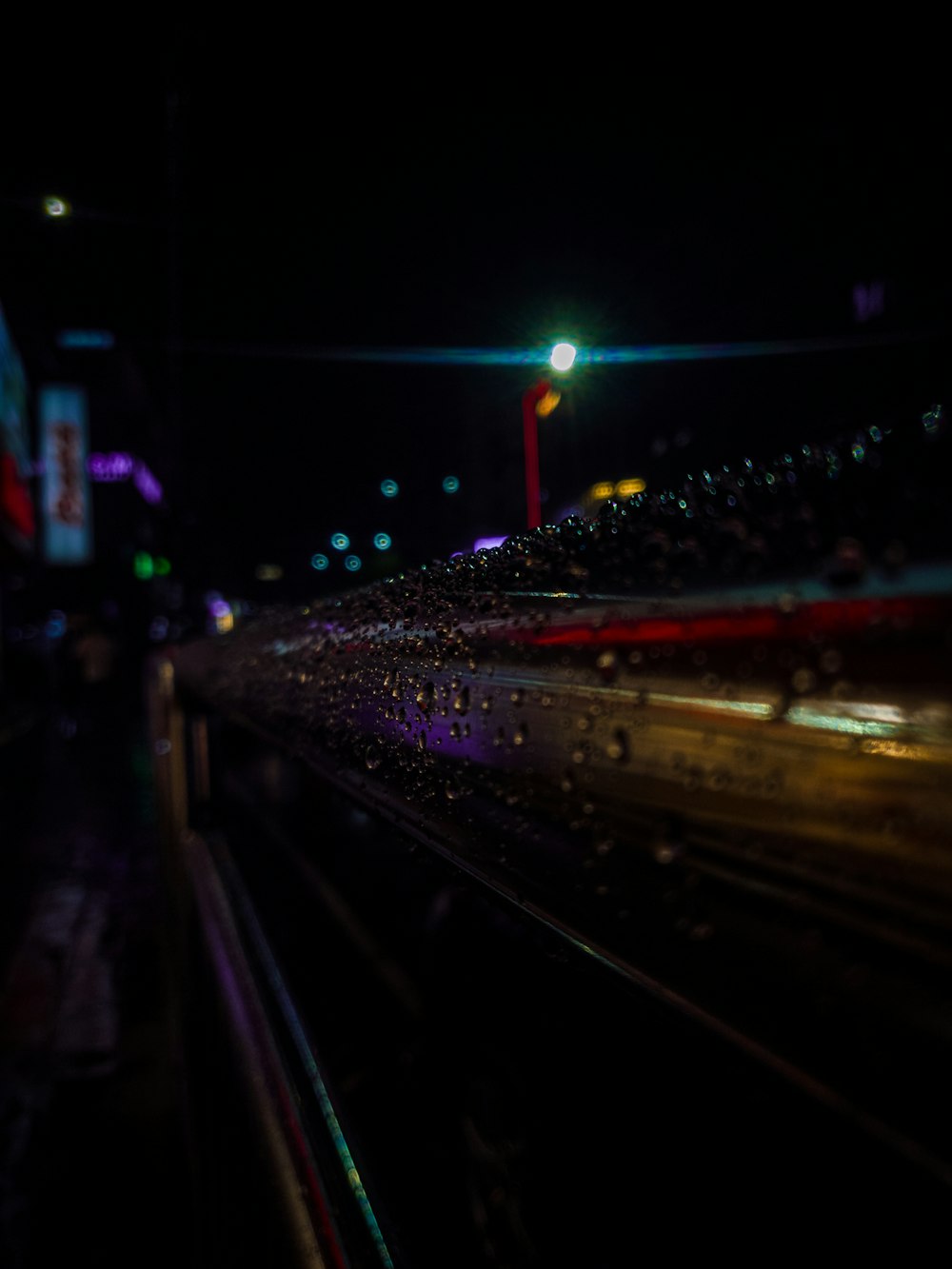 a train traveling down train tracks at night