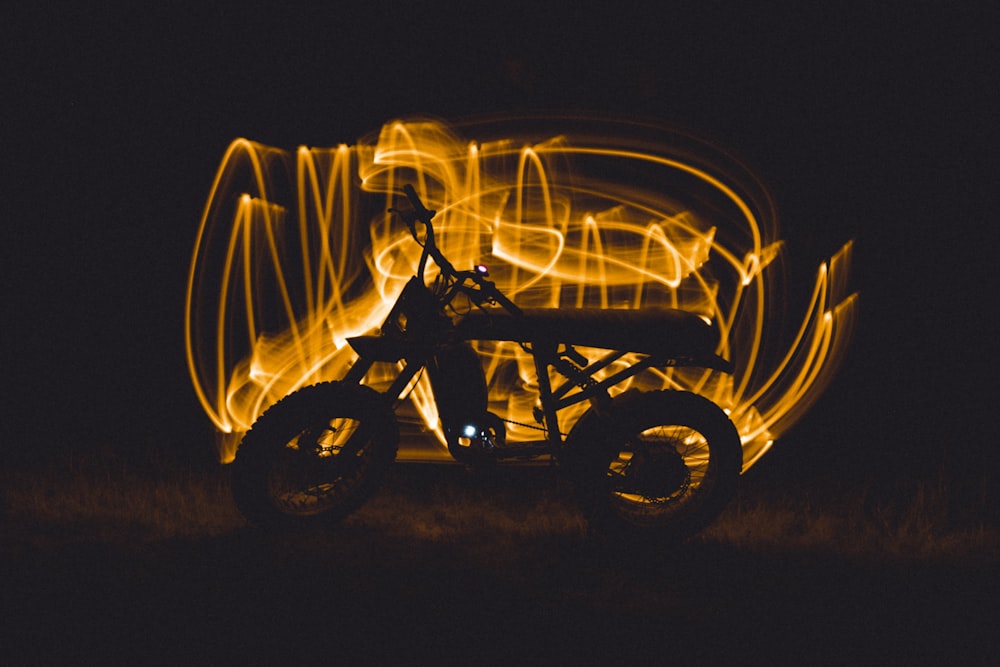 a motorcycle is lit up in the dark