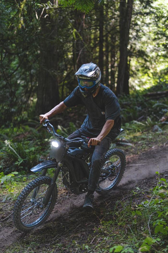 Rider on an electric dirt bike in the forest