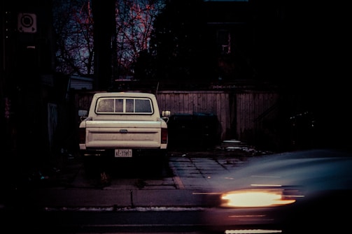 A tow truck parked outside a private client’s home at dusk.