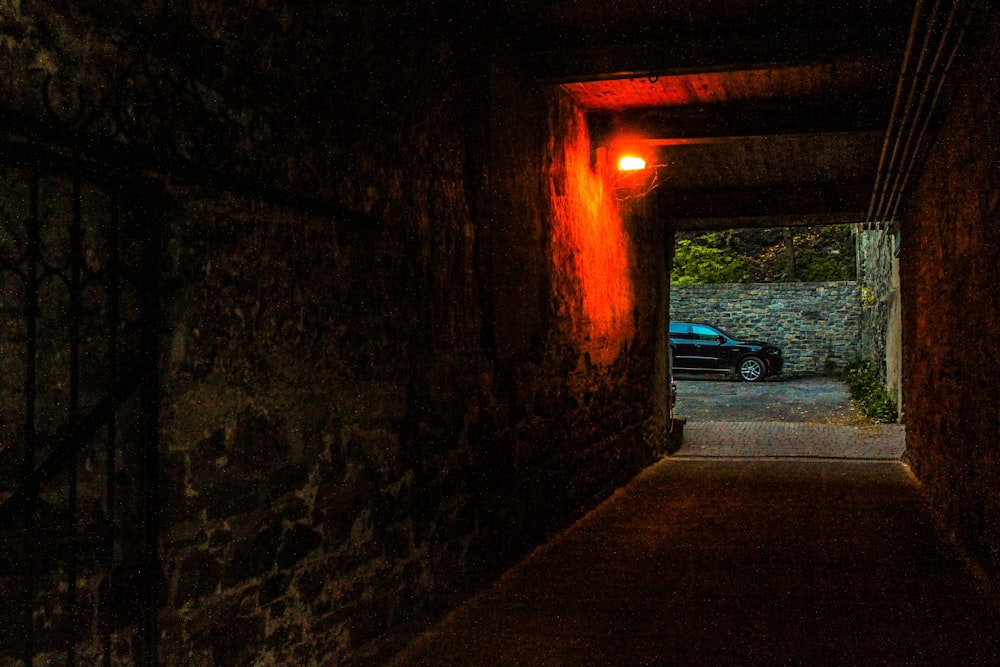 a dark tunnel with a car parked in it