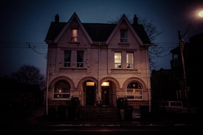 A small duplex nestled in a leafy neighborhood, with neighbors chatting nearby.