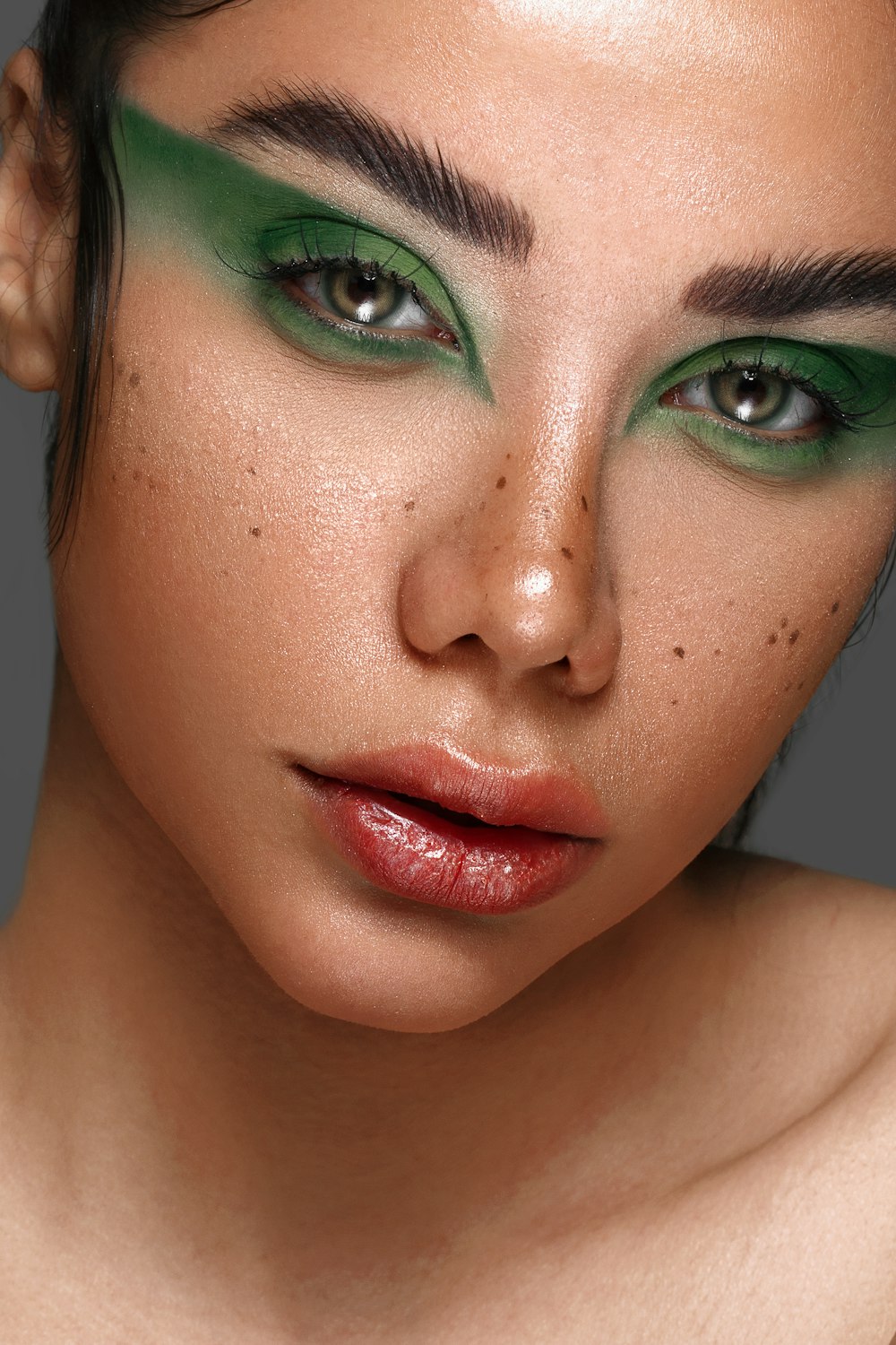 a close up of a woman with green makeup