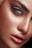 A close-up of a person's face, highlighting a single eye with dramatic makeup. The skin glistens with moisture, showing droplets and a dewy complexion. The makeup consists of bold, dark eyeshadow and thick, defined eyebrows.