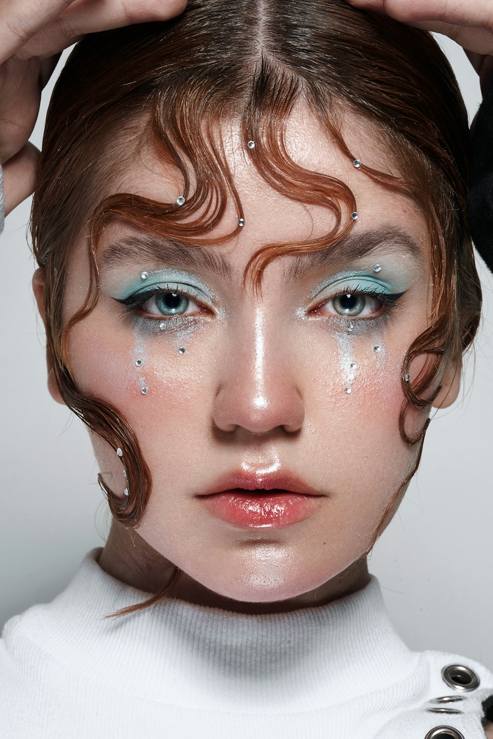 a woman with blue and white makeup is posing for a picture