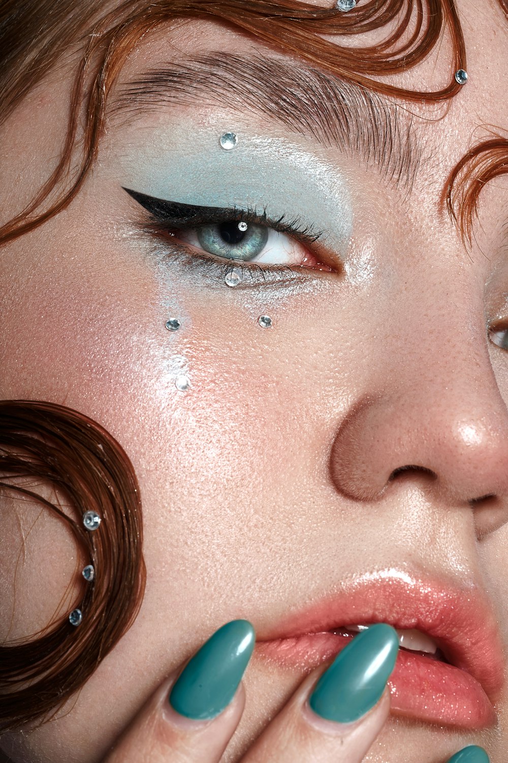 a close up of a woman with blue nails
