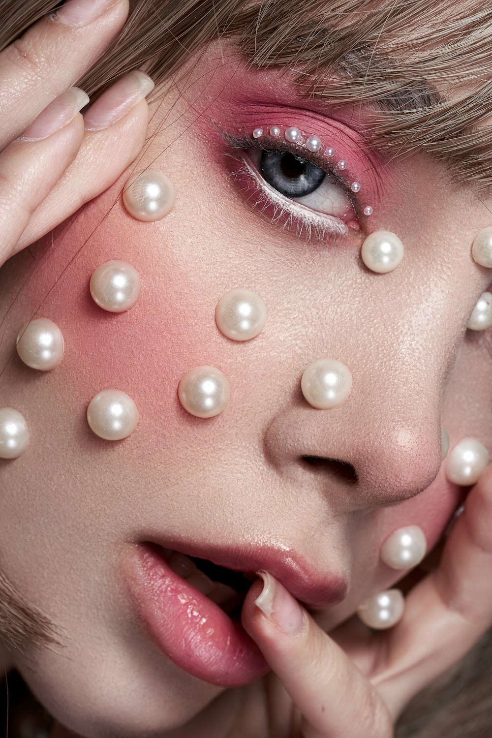 a woman with a lot of pearls on her face
