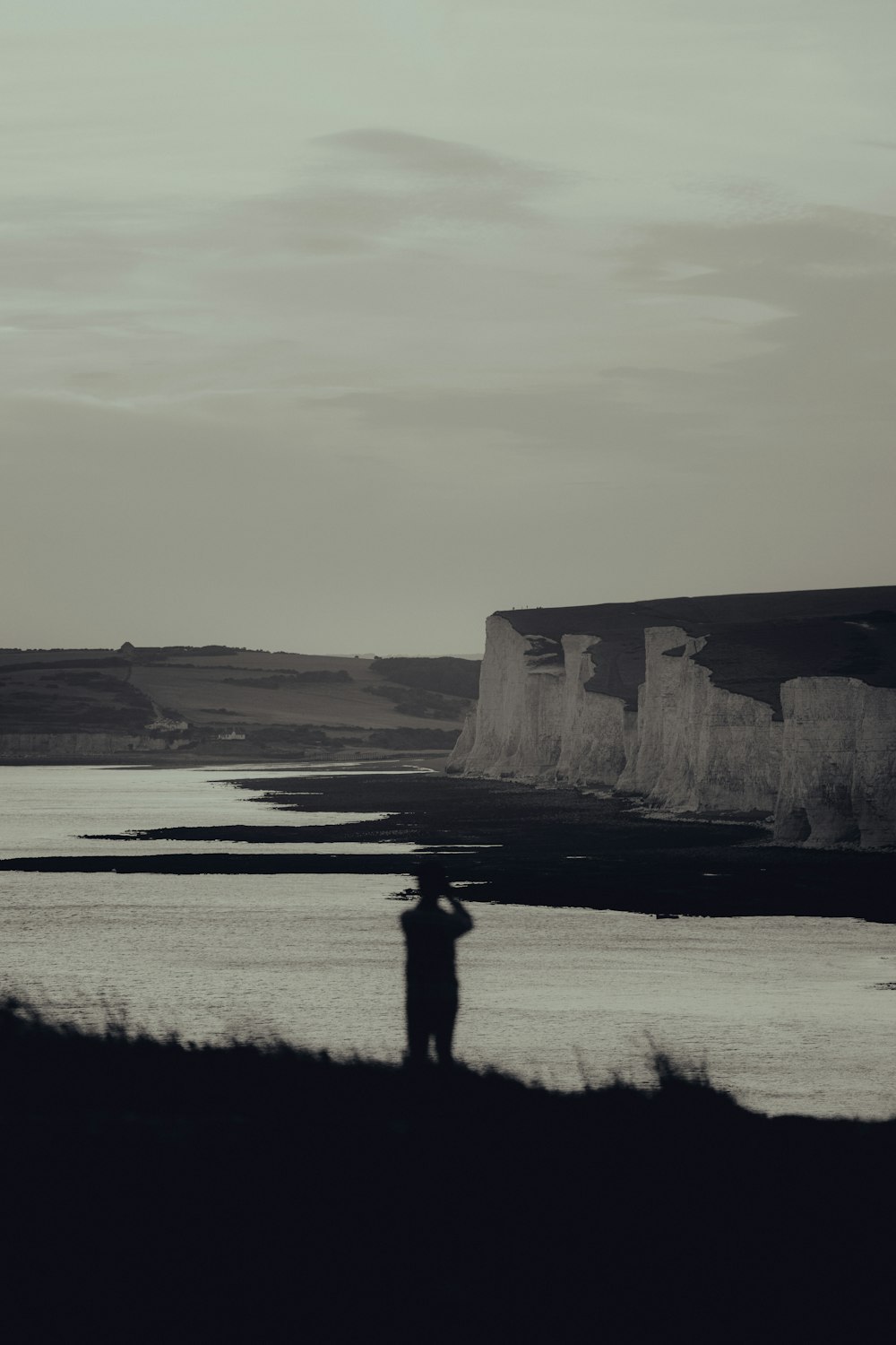 a person standing in front of a body of water