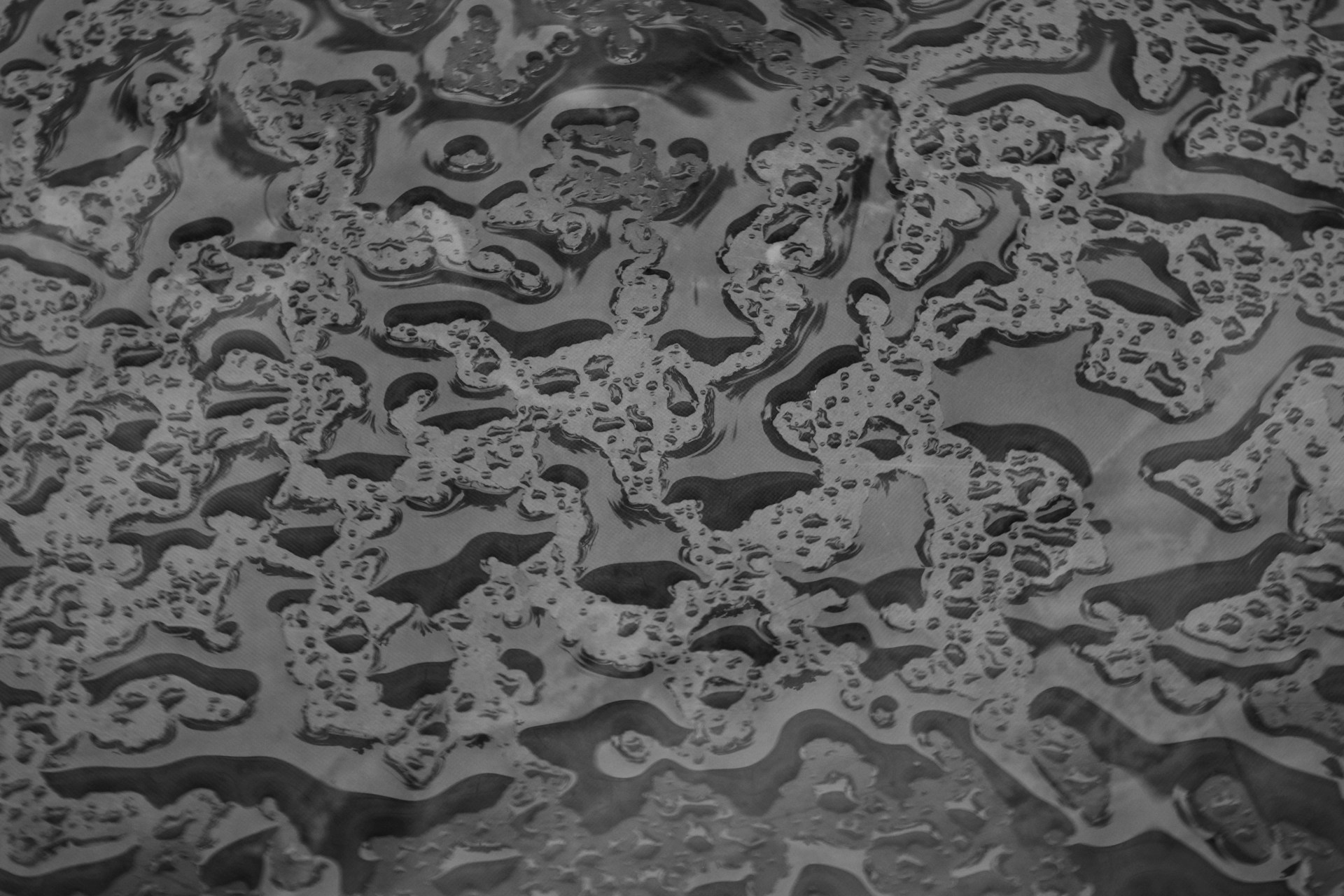 a black and white photo of water and bubbles