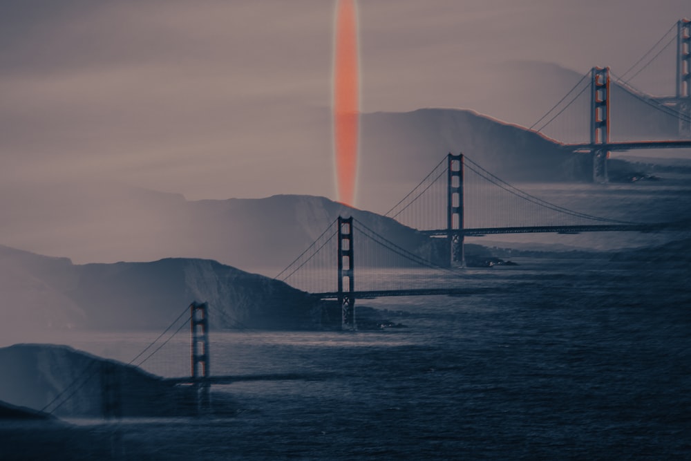 a red object is flying over a bridge