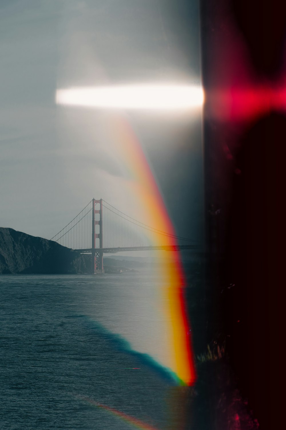 a rainbow in the sky over a body of water