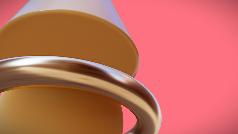 a close up of a metal object on a pink background