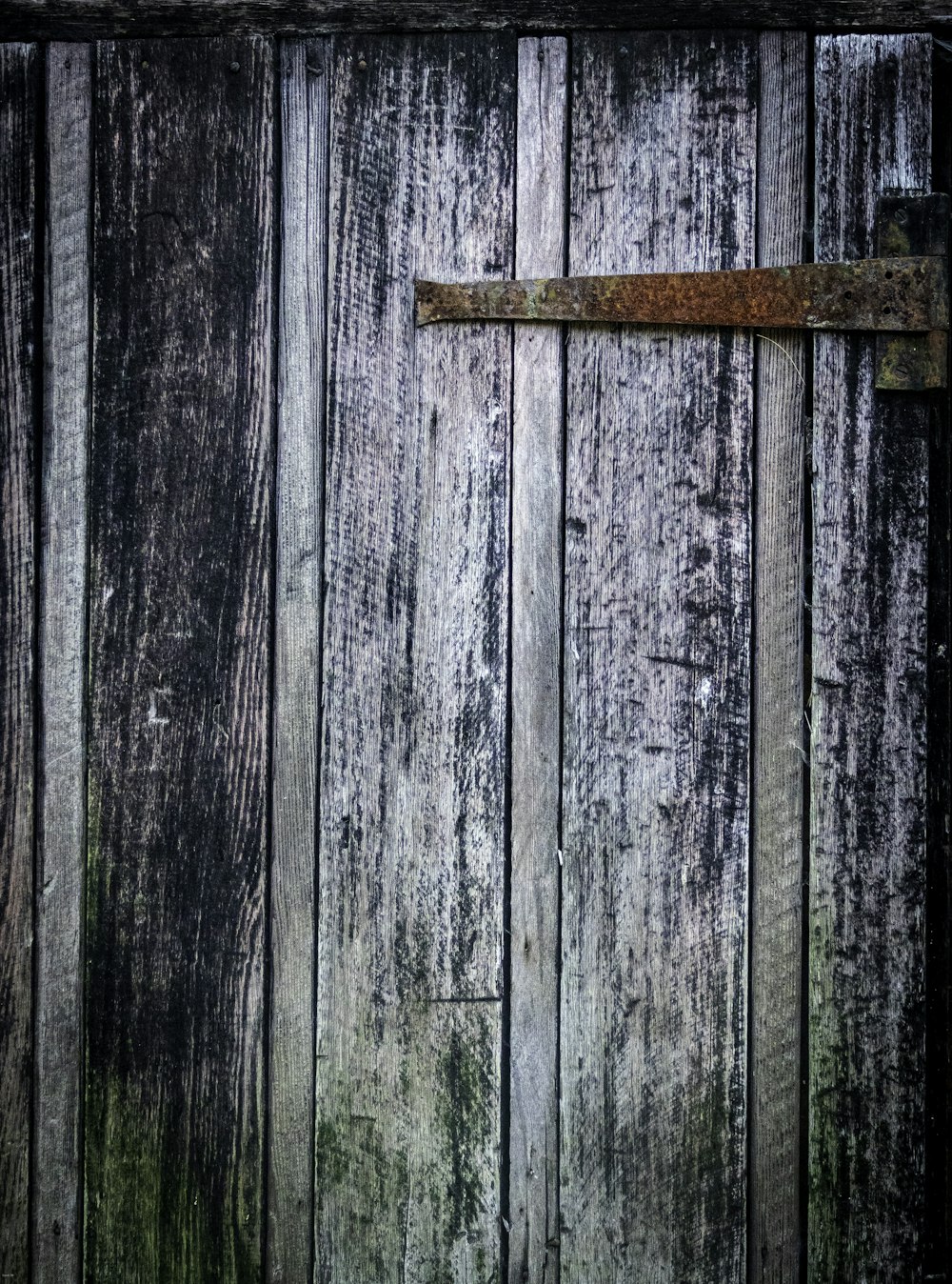 an old wooden door with a rusted handle
