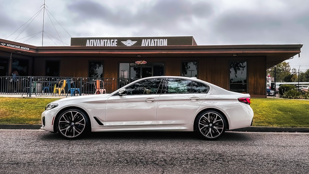 a white car parked in front of a building