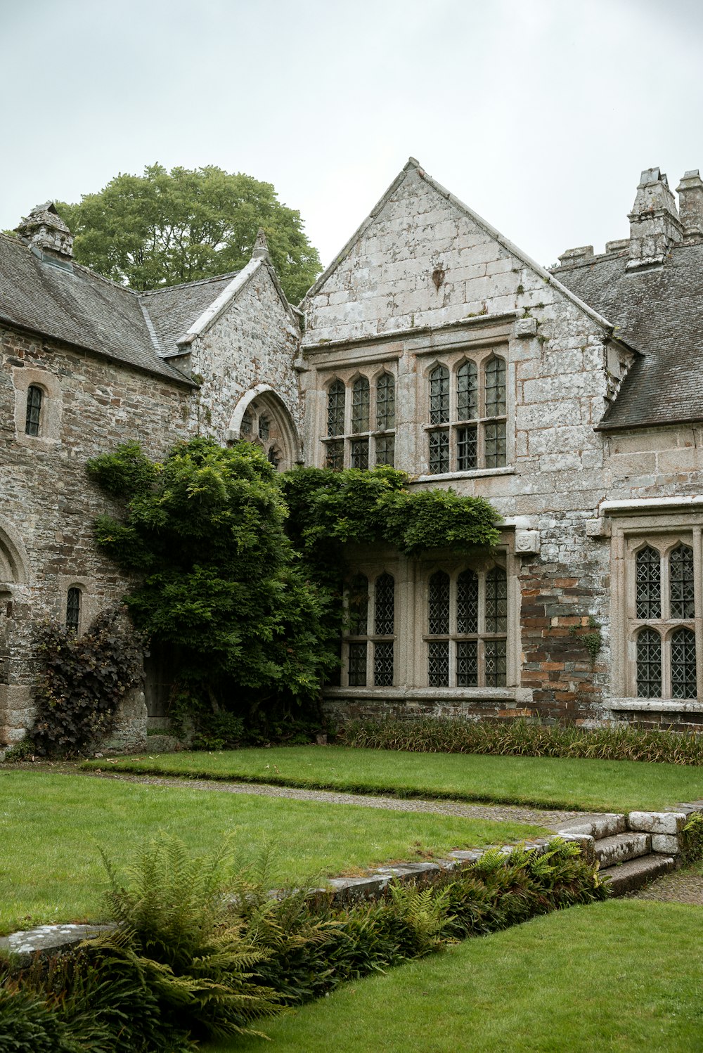 a stone building with a green lawn in front of it