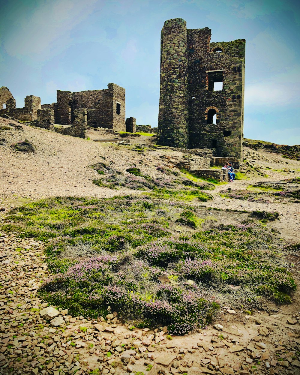 a couple of ruins sitting on top of a hill