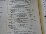 A close-up view of an open book displaying text in two columns. The text is printed in black on cream-colored pages and appears to be from a religious or historical document, given the mention of 'The LORD' and references to events involving kings and nations.
