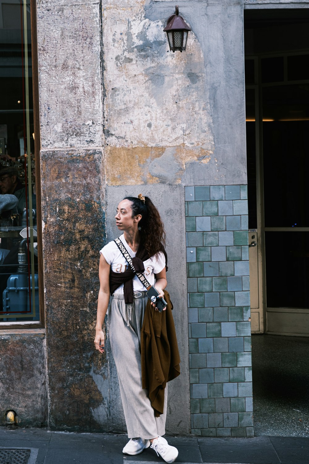 a woman standing in front of a building