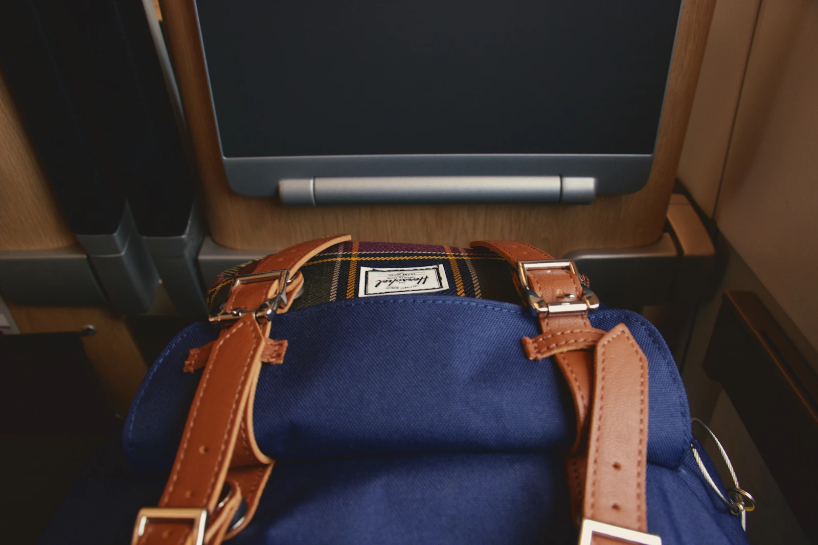 Navy Herschel backpack with tan leather straps
