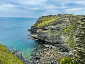 a rocky cliff overlooks a body of water