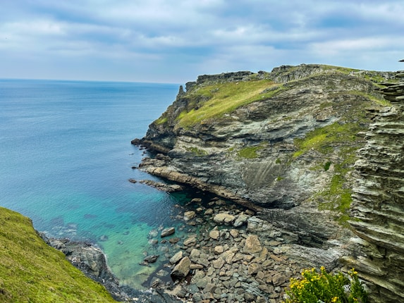 a rocky cliff overlooks a body of water