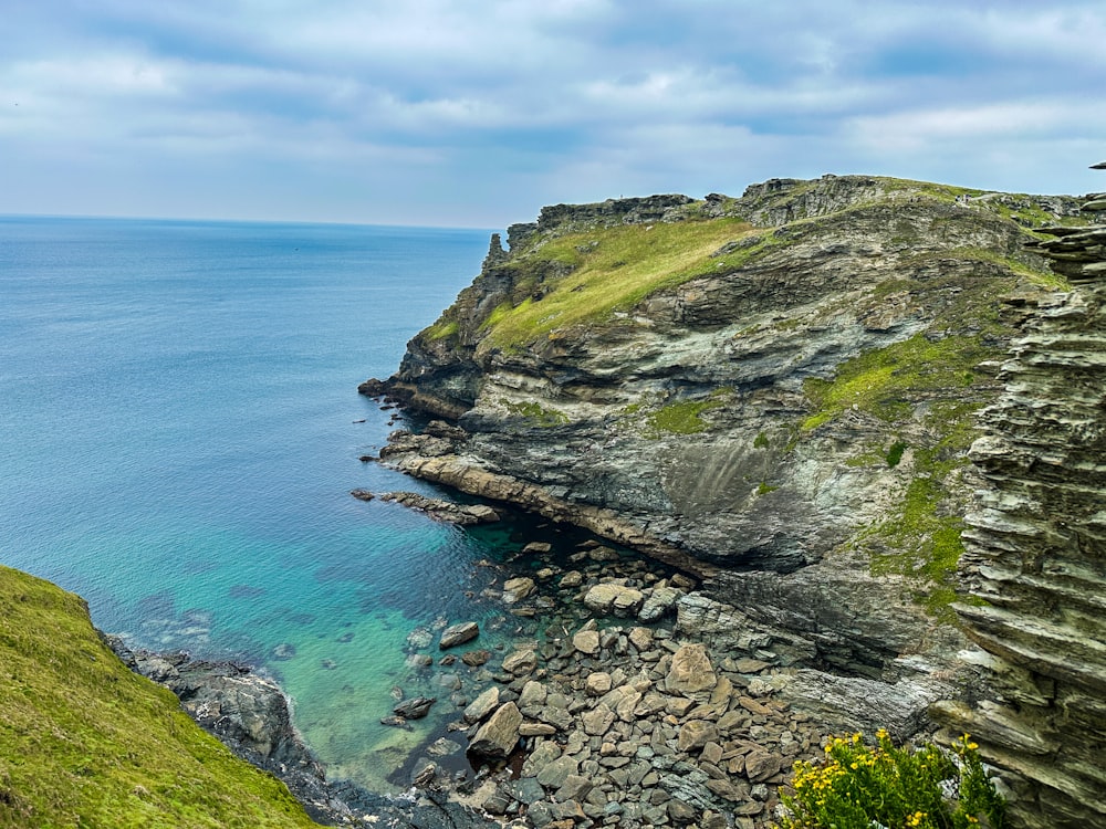 a rocky cliff overlooks a body of water