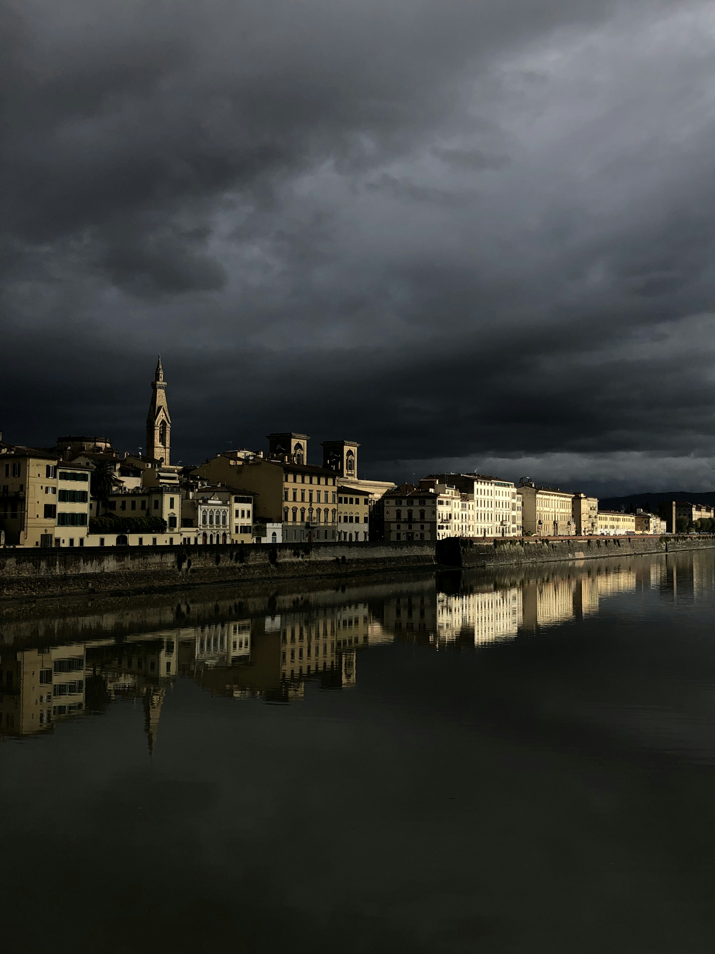 a dark sky is reflected in a body of water