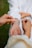 Close-up of a warm handshake between a customer and a craftsman inside a cozy jewelry shop.