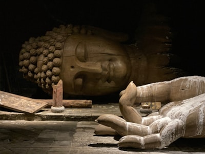 a statue of a person laying on the ground