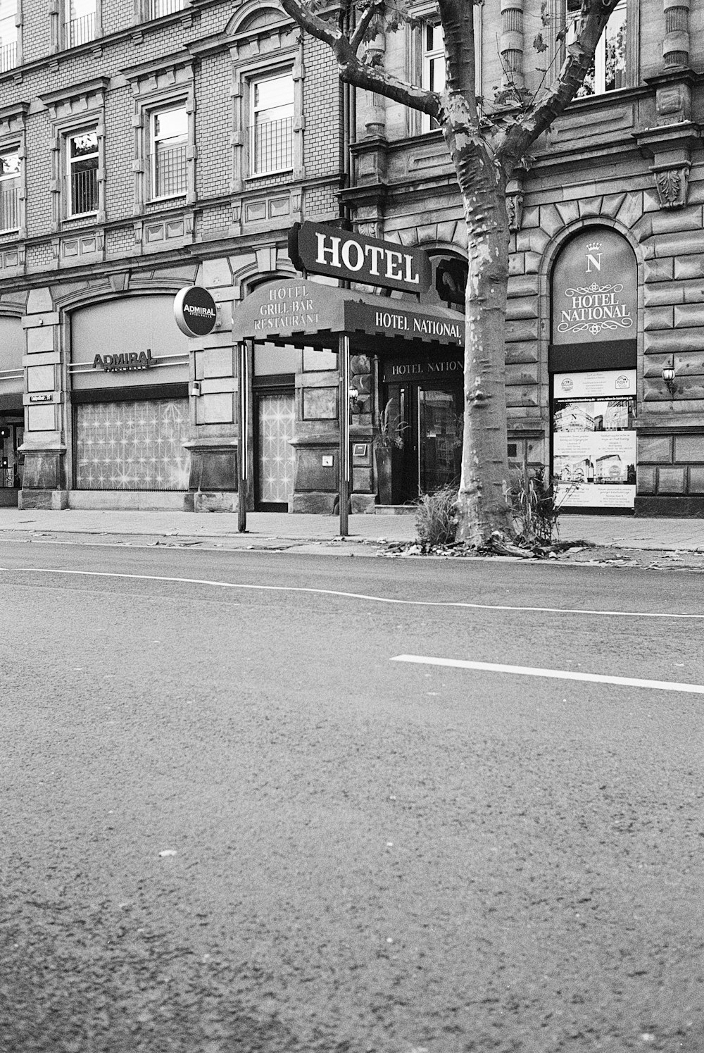 a black and white photo of a street corner