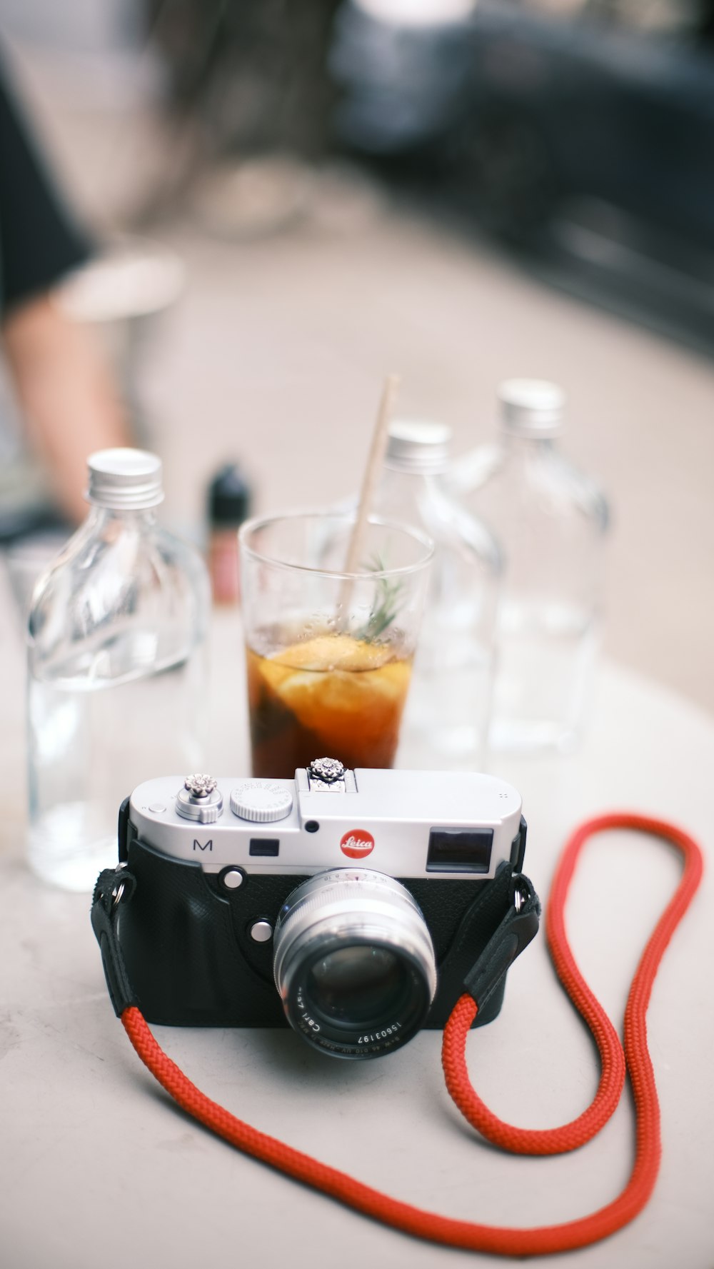 a camera sitting on top of a table next to bottles