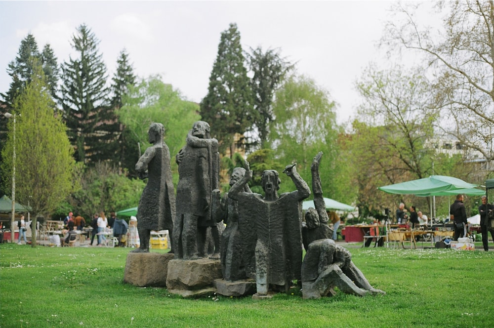a statue of a group of people in a park