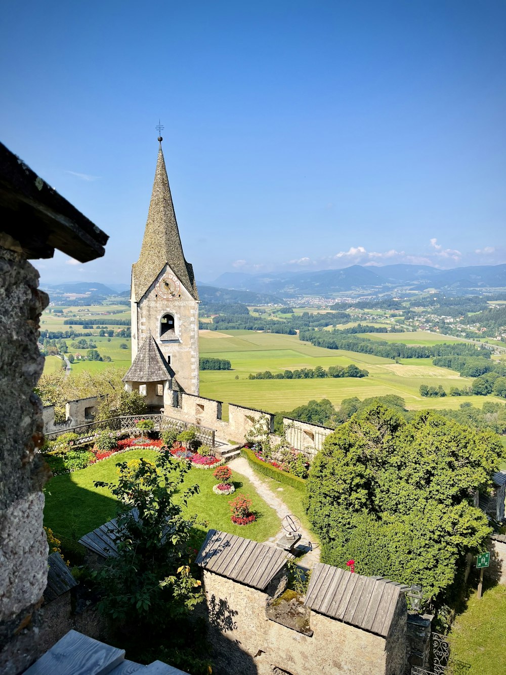 an old church in the middle of a green field