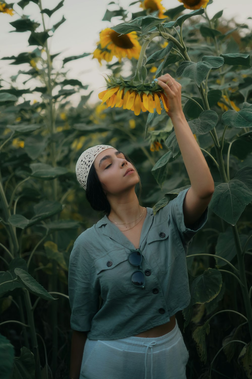 a woman standing in a field of sunflowers