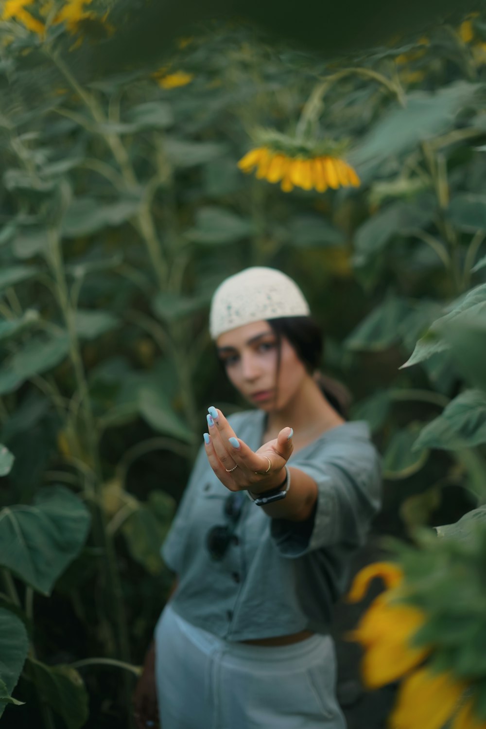 a woman standing in a field of sunflowers