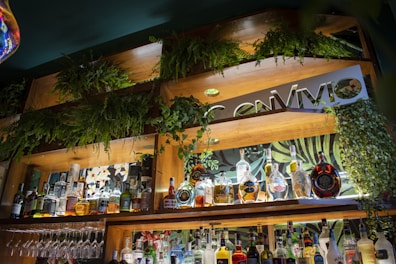 An elegant set of brass barware displayed on a rustic wooden shelf.