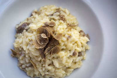 Creamy truffled mushroom risotto garnished with aged parmesan shavings.