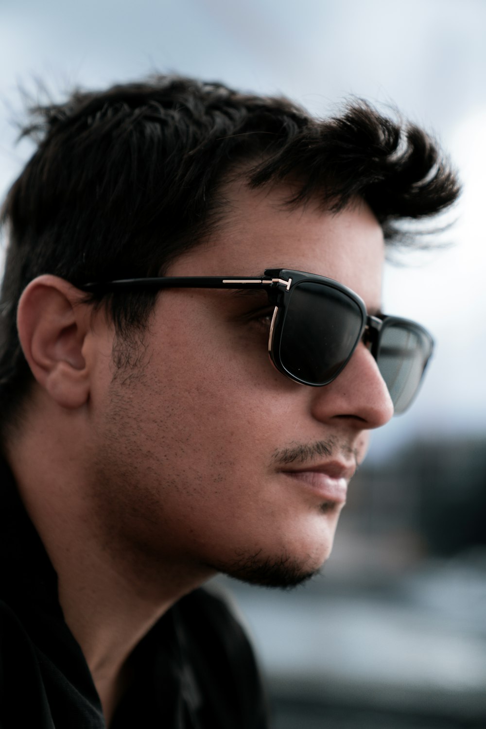 a man wearing sunglasses and a black shirt