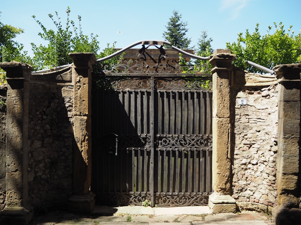 a gate that is surrounded by stone pillars