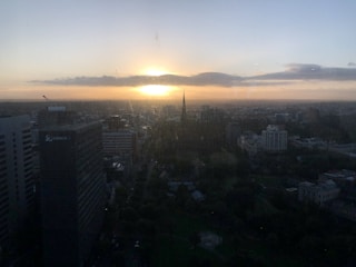 Split image showing London’s iconic skyline and Cairo’s bustling streets under sunset.