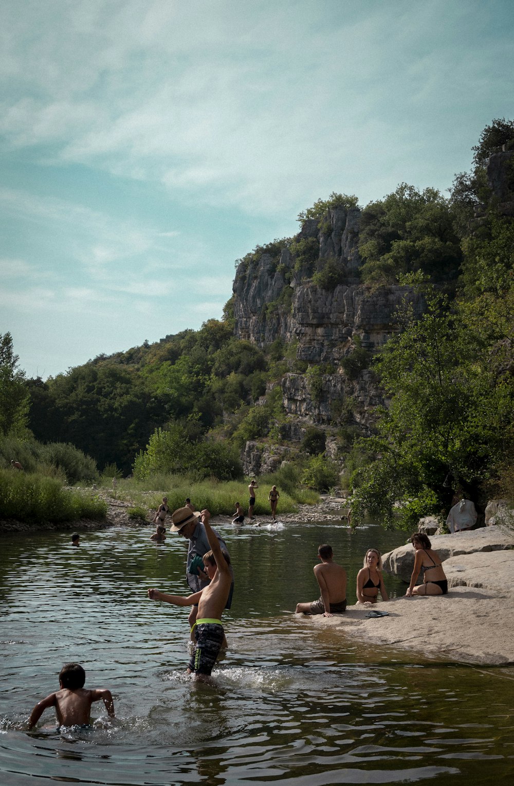 a group of people are wading in a river