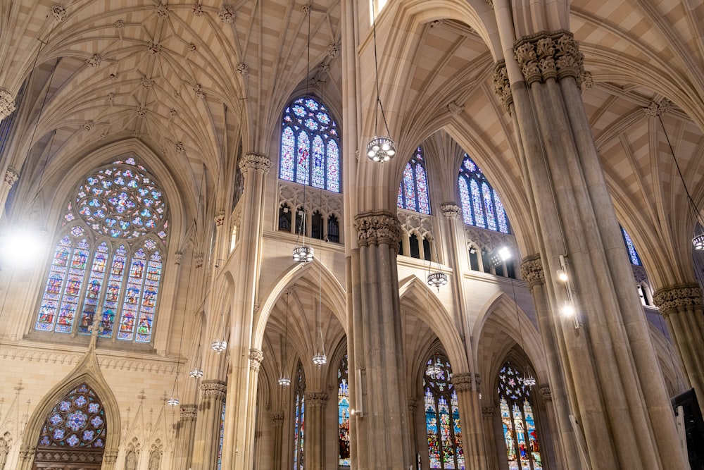the interior of a large cathedral with stained glass windows