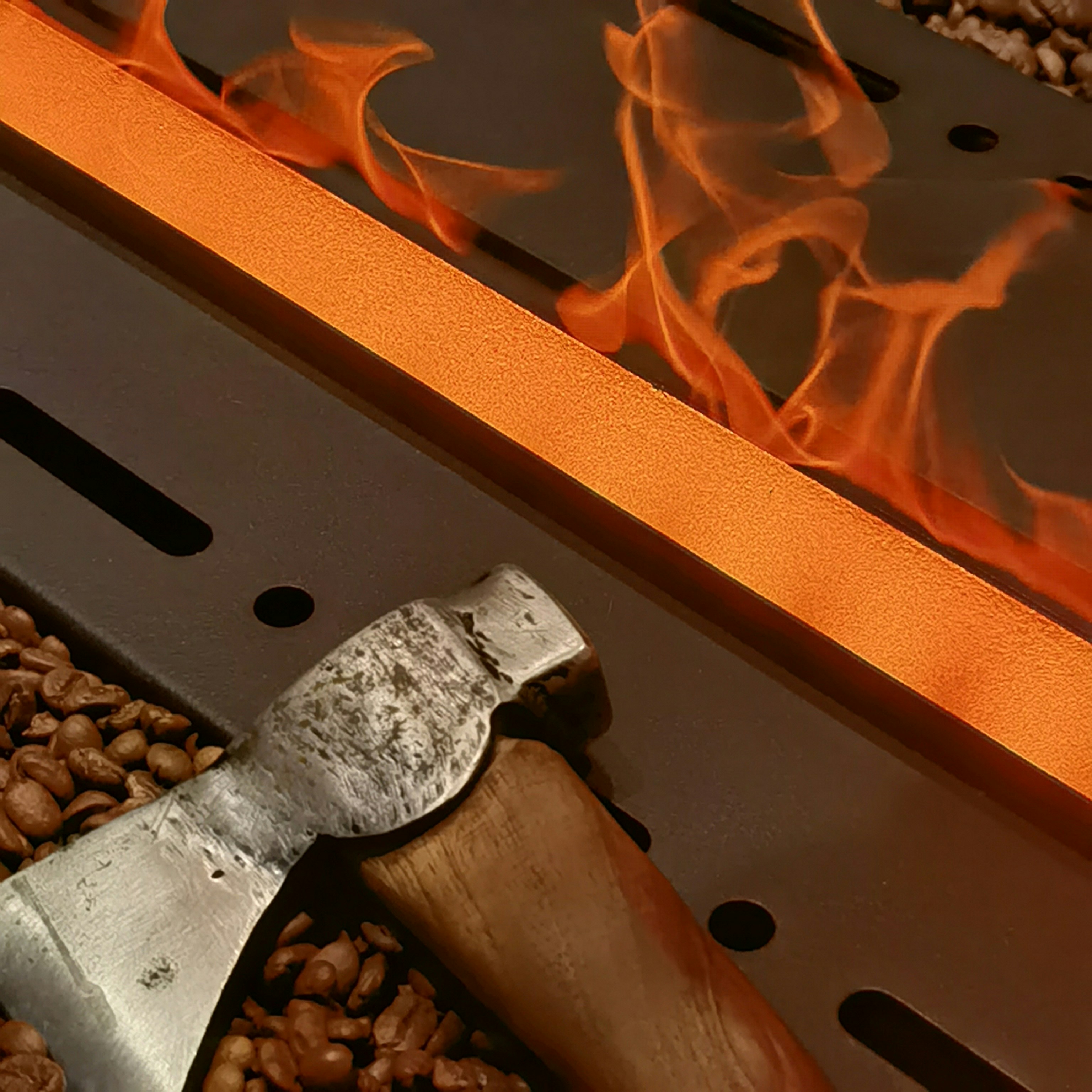 A metal beam glows with intense heat and is surrounded by bright orange flames. In the foreground, a rugged metal and wooden-handled hatchet rests amidst scattered coffee beans, creating a striking contrast between the industrial setting and the organic elements.