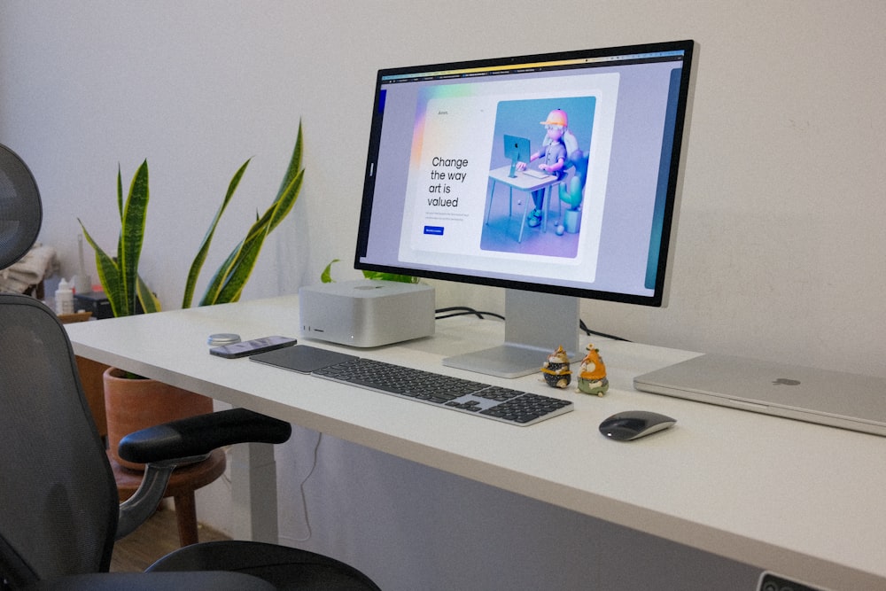 a computer monitor sitting on top of a white desk