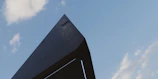 Architectural model showcasing a futuristic building design with clean lines and sharp angles.