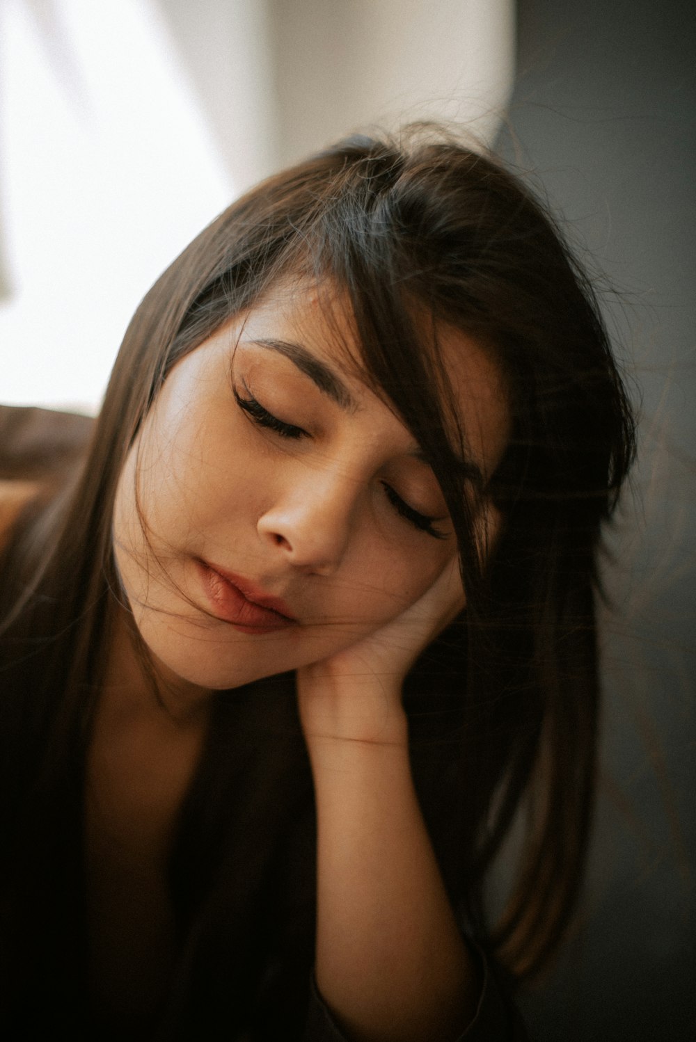 a woman with her hand on her face