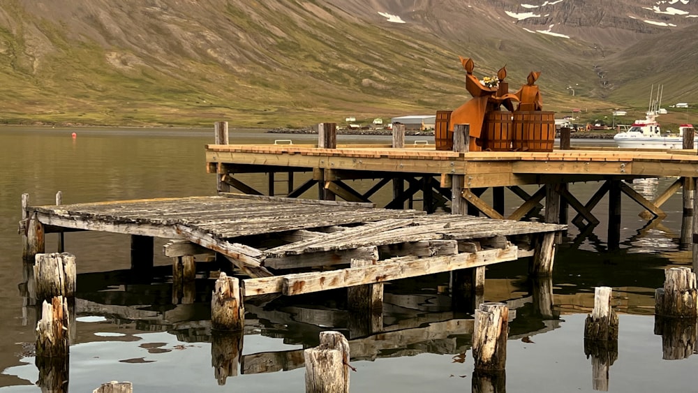 a wooden dock with a couple of horses on top of it