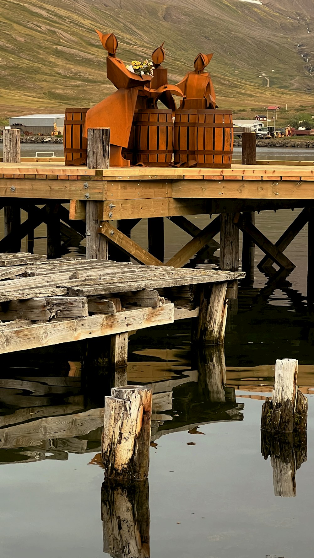 a wooden dock with a couple of wooden horses on top of it